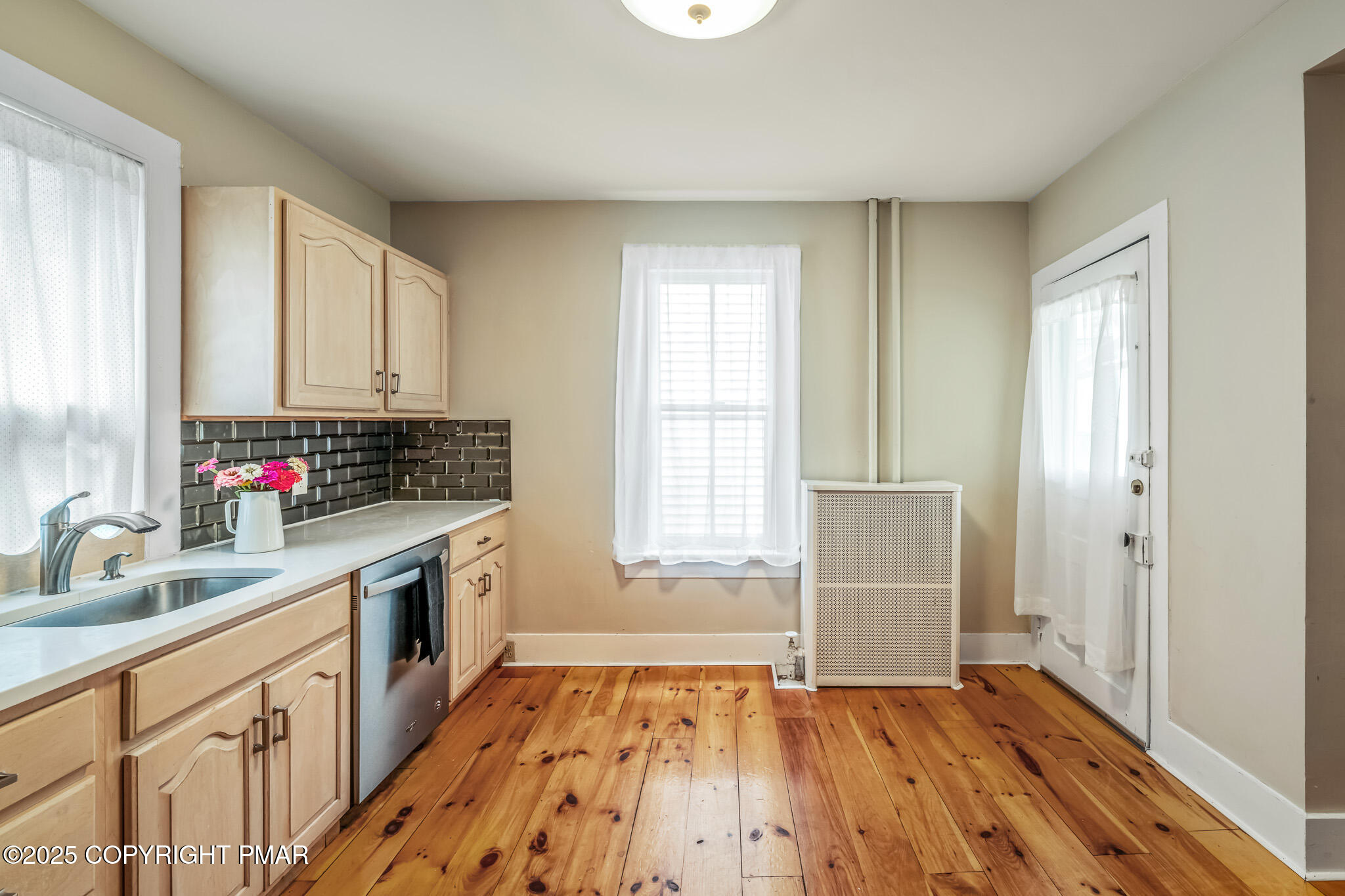 703 Scott Street Stroudsburg, PA 18360 - Photo 7 of 27 a kitchen with wooden floors and white appliances