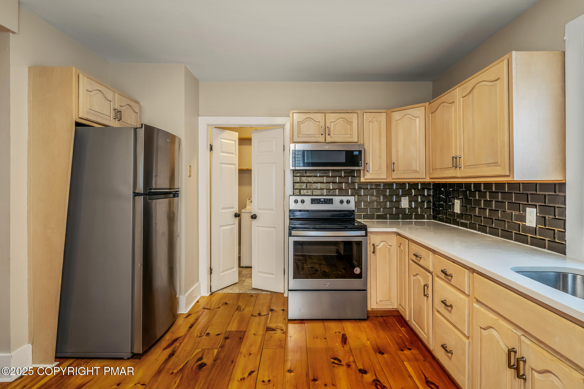 703 Scott Street Stroudsburg, PA 18360 - Photo 8 of 27 a kitchen with stainless steel appliances a refrigerator stove and sink