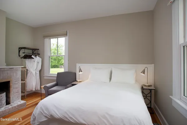 a bedroom with a bed and a fireplace