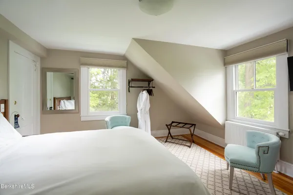 a bedroom with a bed and a large window