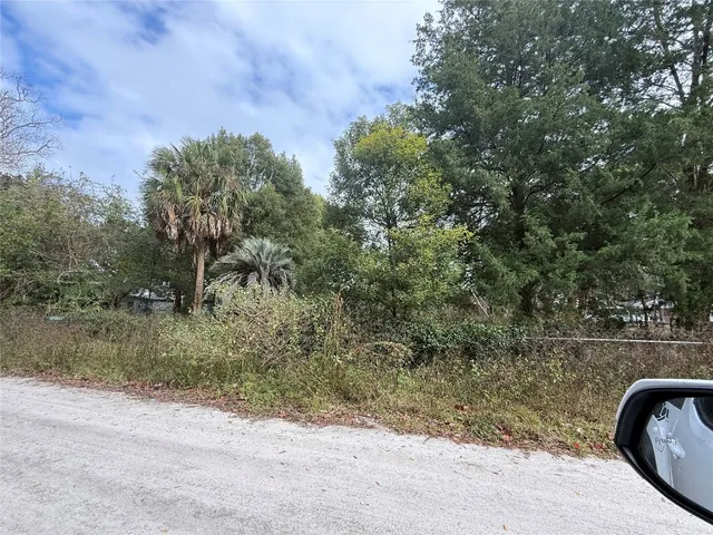 a view of a wooden fence and trees