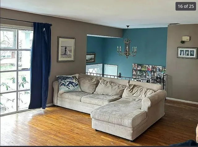 a view of a room with furniture window and wooden floor