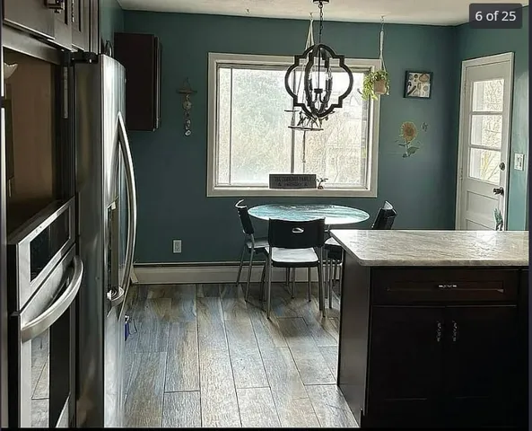 a kitchen with a table chairs and refrigerator