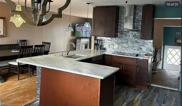 a kitchen with kitchen island granite countertop a sink a counter top space and appliances