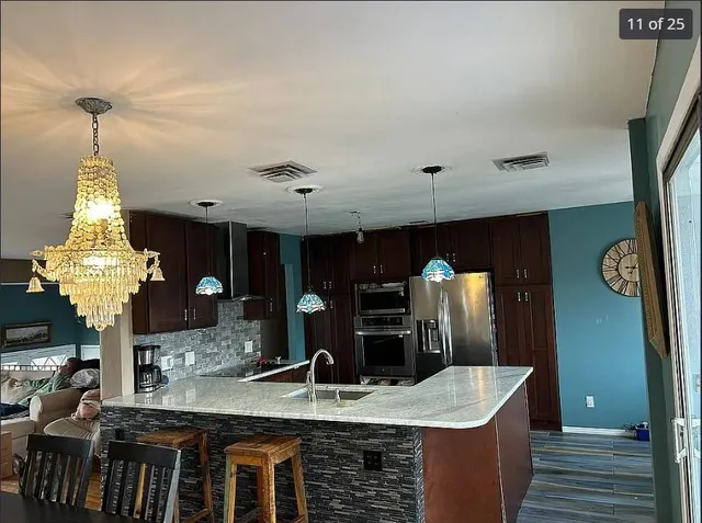 a view of a kitchen area with furniture and chandelier