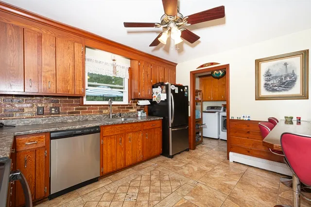 a view of kitchen with stainless steel appliances granite countertop cabinets and a sink