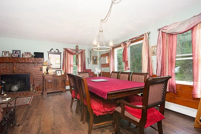 a dining room with furniture window and wooden floor