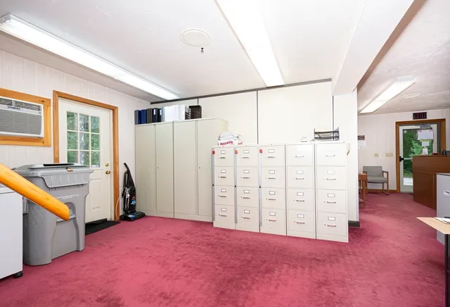 a view of a bedroom with furniture and window
