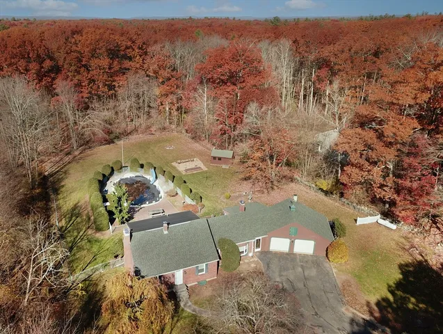 an aerial view of a house with a yard