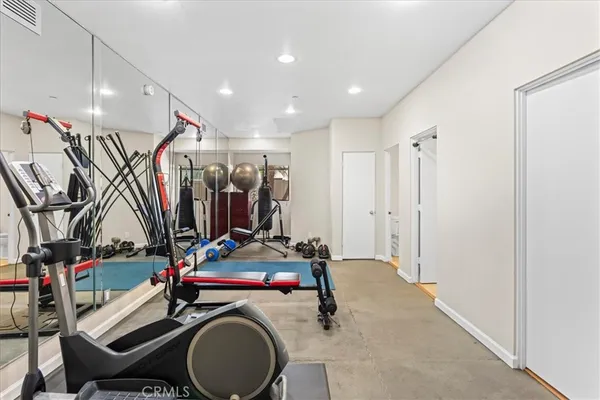 a room with gym equipment and a mirror