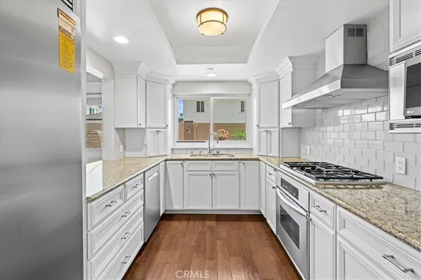 a kitchen with a refrigerator and a sink