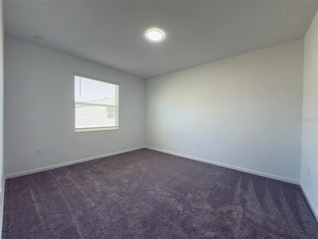 an empty room with a empty space and windows