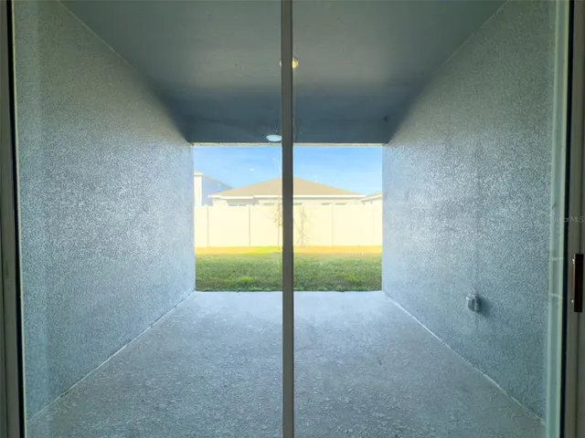 a view of an empty room and window
