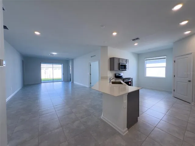 a kitchen with granite countertop a sink and a stove top oven