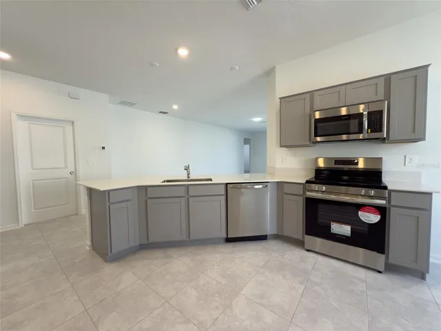 a kitchen with a stove and a microwave