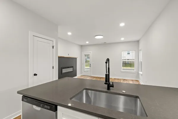 an empty room with windows and fireplace