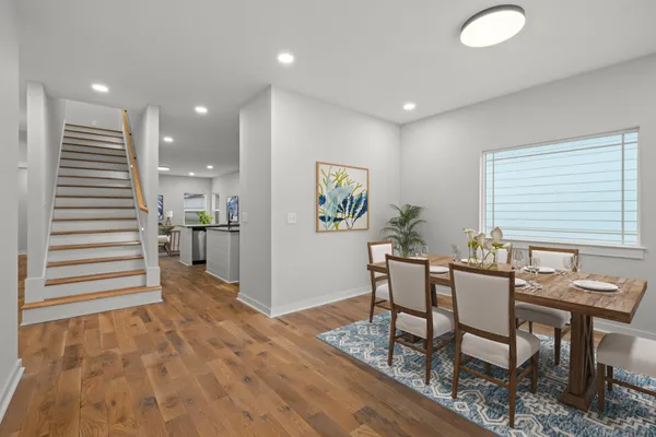 a view of a hallway with stairs and a window