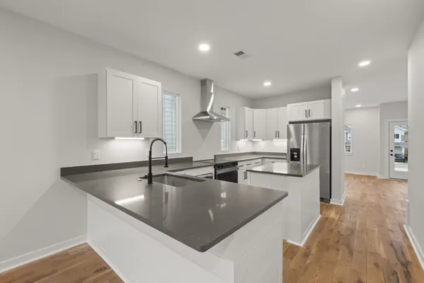 a kitchen with granite countertop a sink and cabinets