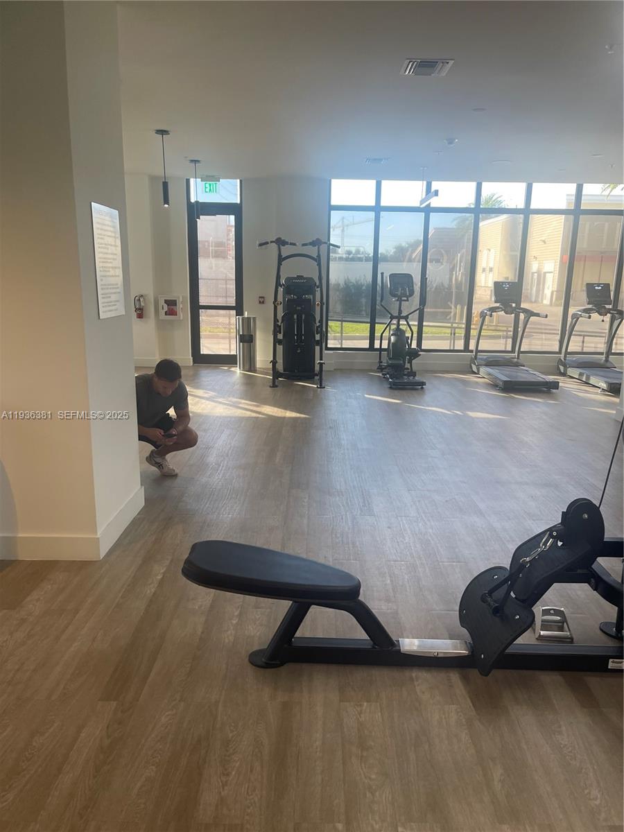 4465 Griffin Road, Unit 1 Hollywood, FL 33314 - Photo 11 of 13 a room with gym equipment and a large window