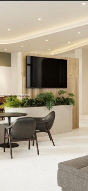 4465 Griffin Road, Unit 1 Hollywood, FL 33314 - Photo 6 of 13 a living room with a table and chairs