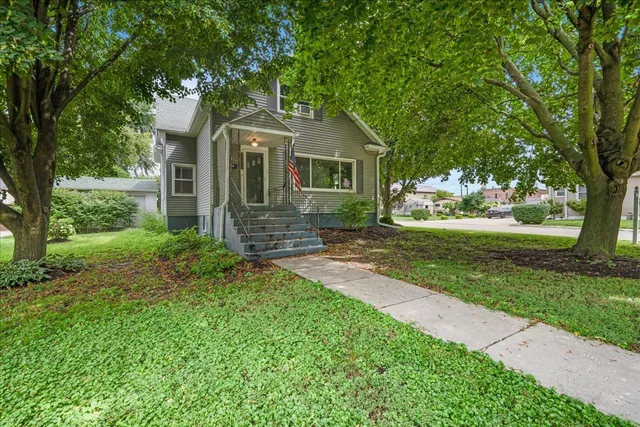 a front view of house with yard and green space