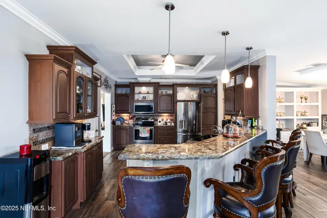 a kitchen with a refrigerator stove and sink