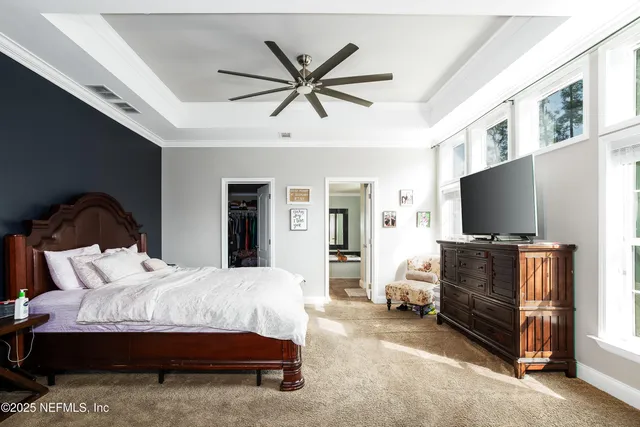 a bathroom with a granite countertop sink and a large mirror