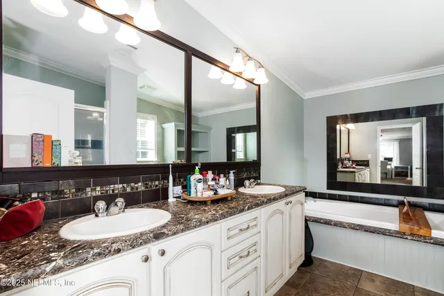 a bathroom with a granite countertop sink and a mirror with toilet