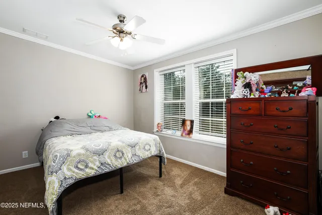 a bedroom with bed and a window