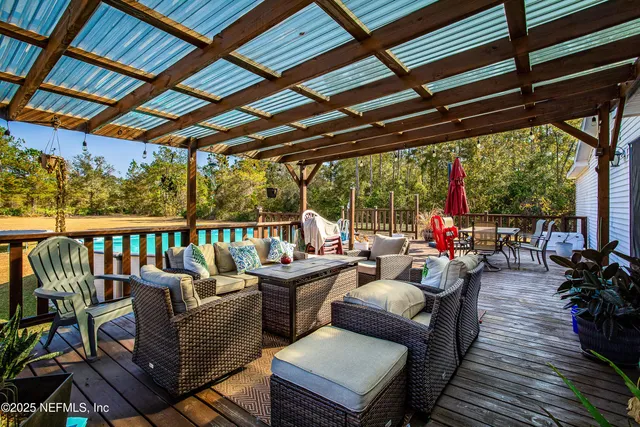 a balcony with wooden floor and outdoor seating