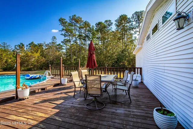 a view of a swimming pool with an outdoor seating and a yard