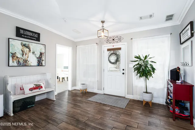 a living room with lots of furniture and kitchen view