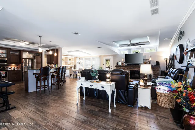 a living room with furniture a flat screen tv and a fireplace