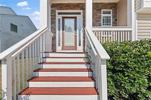 a view of entryway with wooden floor and front door