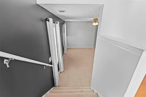 a view of closet with wooden floor