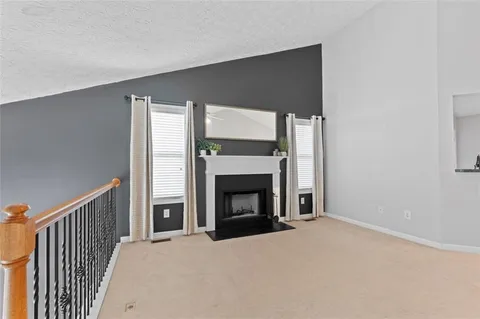 a big room with fireplace and a window