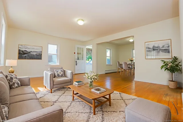 a living room with furniture and wooden floor
