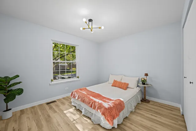 a bedroom with a bed and a window