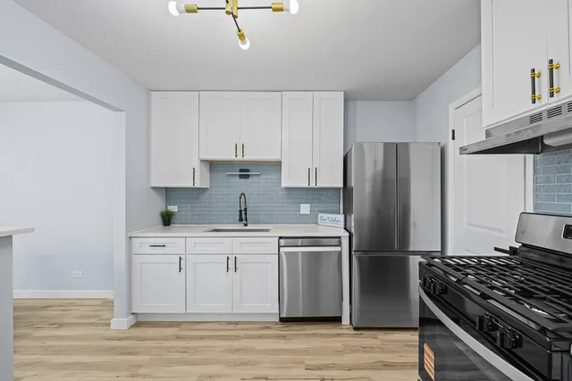 a kitchen with stainless steel appliances a refrigerator stove and sink