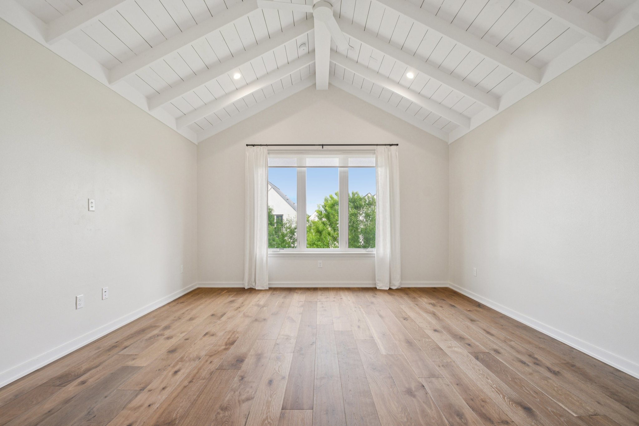 2518 Watkins Way Austin, TX 78746 - Photo 15 of 28 an empty room with wooden floor and windows