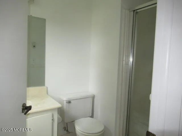 a white toilet sitting next to a shower