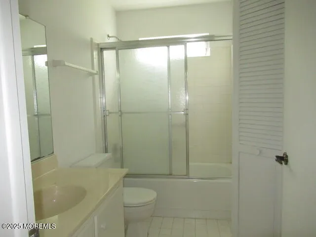 a bathroom with a shower a bathtub and toilet
