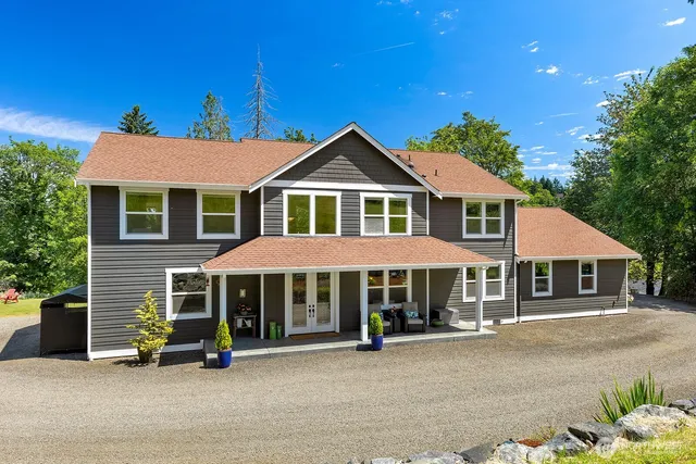 a kitchen with stainless steel appliances kitchen island granite countertop wooden floors and wooden cabinets
