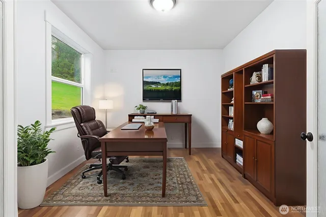 a view of a room with wooden floor and white walls