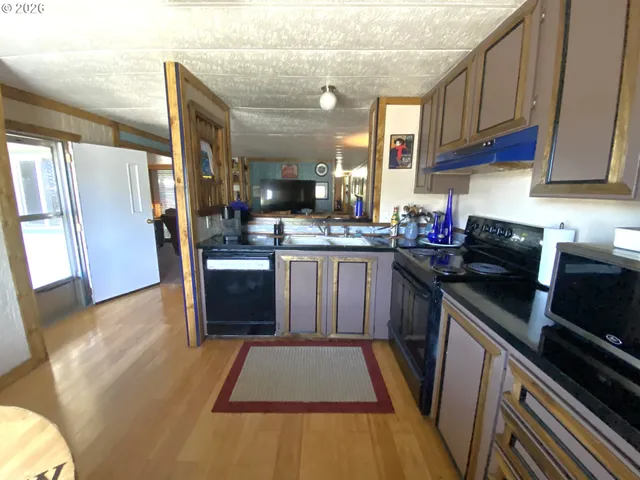 a kitchen with a sink appliances and cabinets
