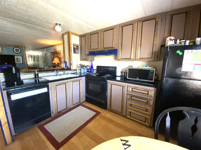 a kitchen with a sink stove and microwave