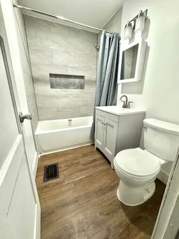 a bathroom with a sink toilet and shower