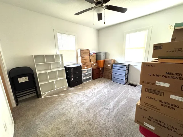 a view of a livingroom with furniture and a window