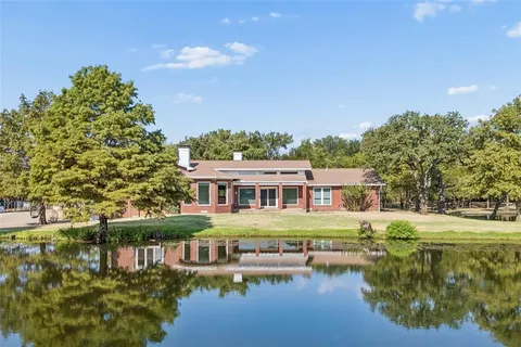 a view of a lake with a house in the background