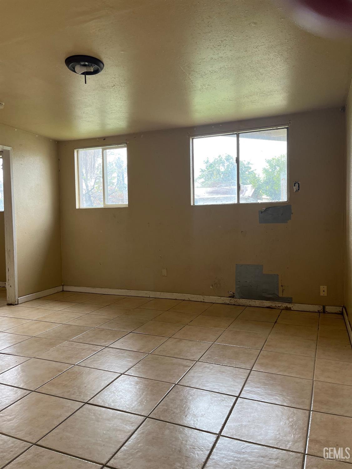 Undisclosed Address Wasco, CA 93280 - Photo 11 of 17 a view of an empty room with a window